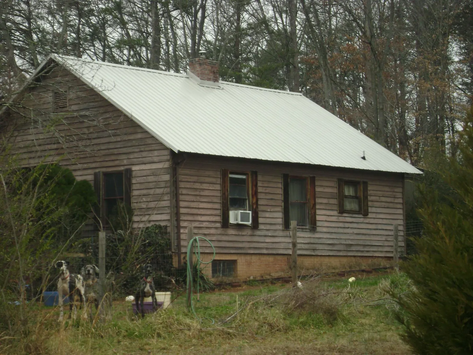 White metal roof on an old wood sided farmhouse, from a Metal Roof Installation job in Lake Ariel
